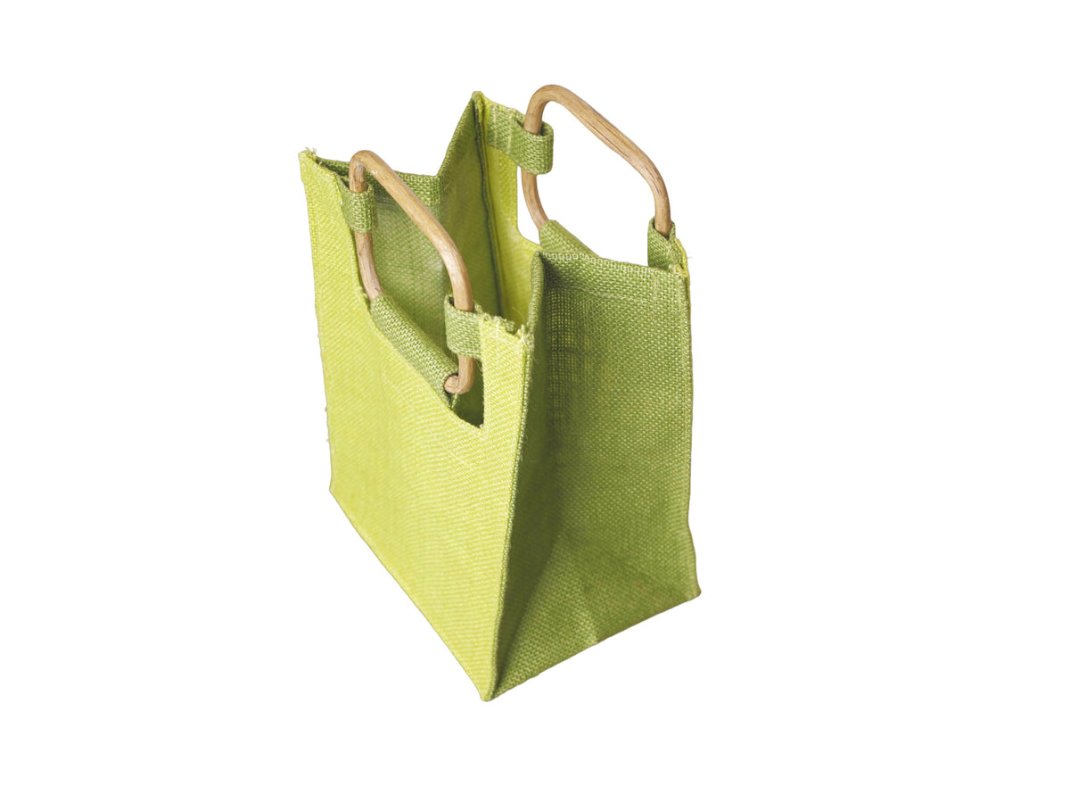 A lime green woven jute tote bag with cane handles, facing 45 degrees to the left from an angled aerial view, shown on a plain white background.