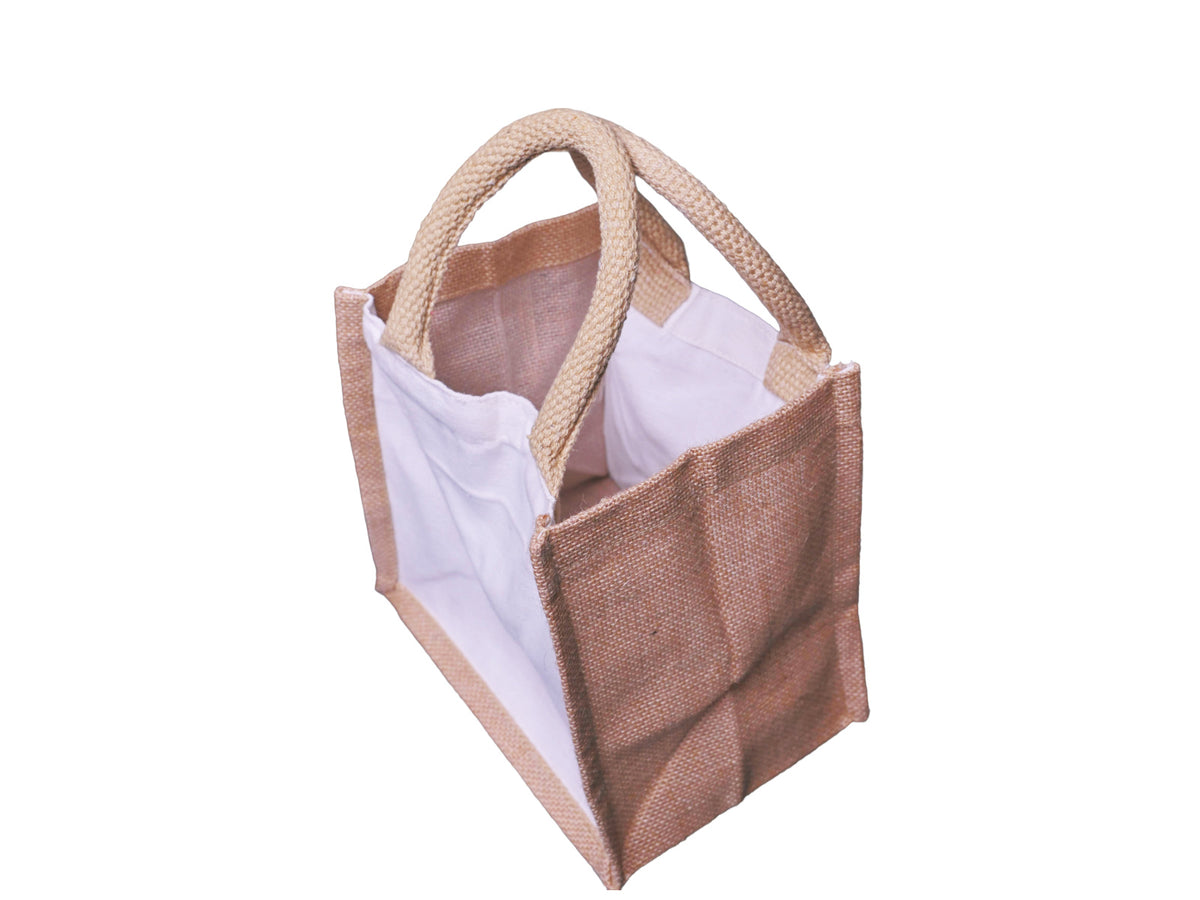 A large hybrid canvas-jute tote bag with canvas front and back panels, jute side panels, and cotton cord handles, looking 45 degrees to the left, and an aerial view, shown on a plain white background.