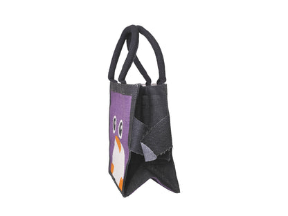 A small black jute tote bag with a purple front panel featuring a cartoon penguin face in white and orange, facing side on, shown on a plain white background.